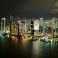 A captivating city skyline lit up by vibrant lights against the dark sky.